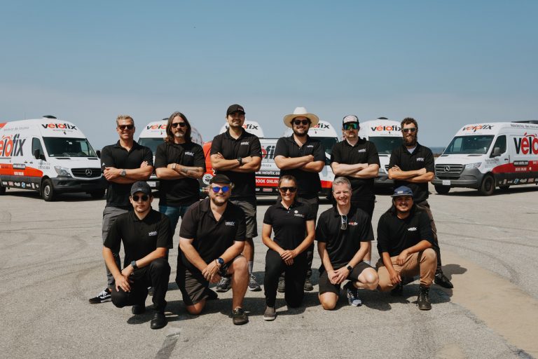 Close up of Velofix Los Angeles team in front of velofix vans